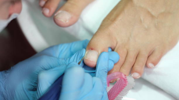 istock Master in gloves making pedicure on toenails in beauty salon using drill closeup 1477707196