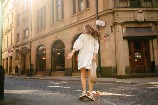 Young beautiful woman walking the streets of an Italian town. Travel and tourism concept.
