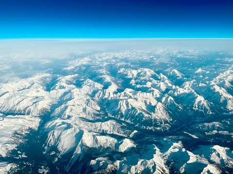 High altitude panoramic view across the crisp white glaciers, snow capped summits and dramatic rocky ridges of the Alps high in the idyllic mountain wilderness of the Bernese Oberland and Valais, Switzerland. ProPhoto RGB profile for maximum color fidelity and gamut.