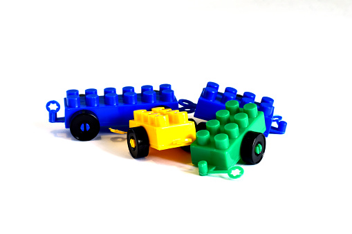 Different color, but the same shape of the details of the children's plastic building block constructor with wheels.