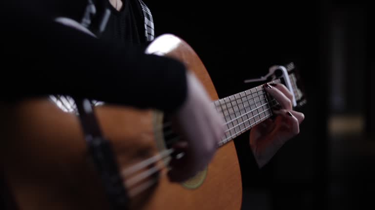 Woman playing guitar in studio light, Play guitar, Teen Girl Playing Acoustic Guitar Close Up,Woman's hands playing acoustic guitar