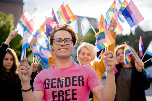 さまざまなlgbtq+の旗を持つプライドイベント活動家 - homosexual rainbow gay pride flag flag ストックフォトと画像