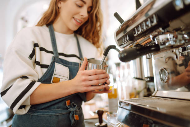 istock Female barista making coffee in a coffee machine. 1477724115