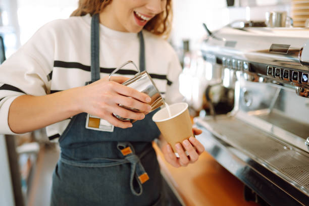 istock Female barista making coffee in a coffee machine. 1477724138