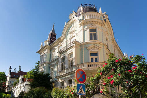 Late 19th century historic house in Bratislava with red roses and clear blue sky for copy space