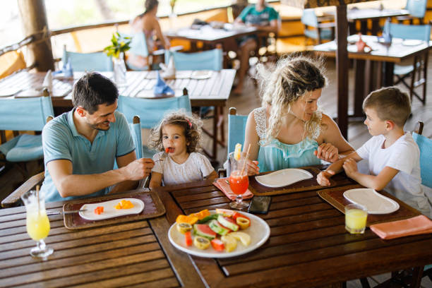 istock Happy family talking while having lunch at restaurant's terrace. 1477727503