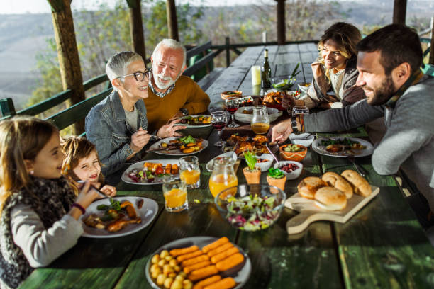 istock Happy extended family talking during lunch on a terrace. 1477729079