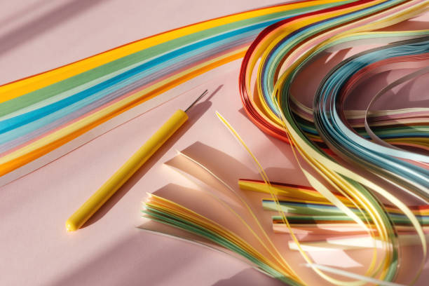 istock Paper and quilling tools on a pink background with space for text and design. 1477730478
