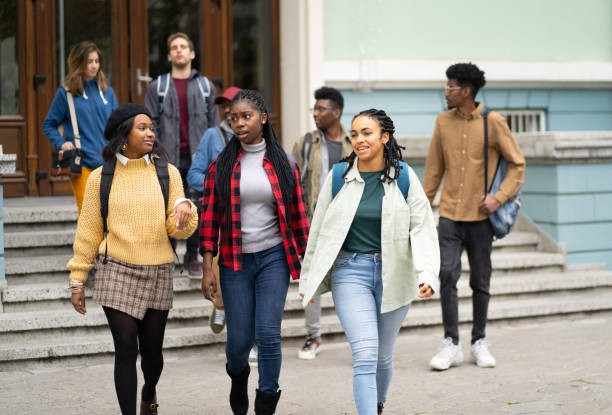 istock Group of college students enjoying walking together between classes on campus 1477731230