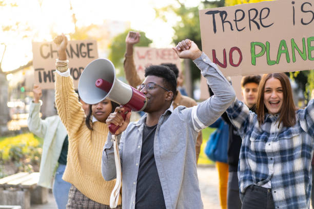 istock Group of people standing up for climate change 1477731307