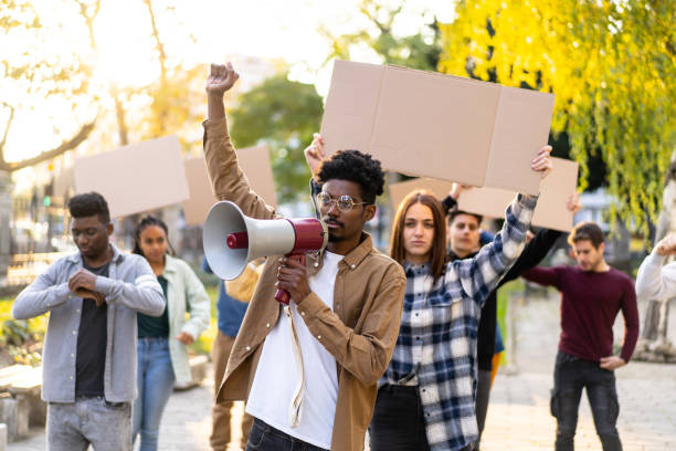 istock Protestors holding a rally in a public park 1477731310
