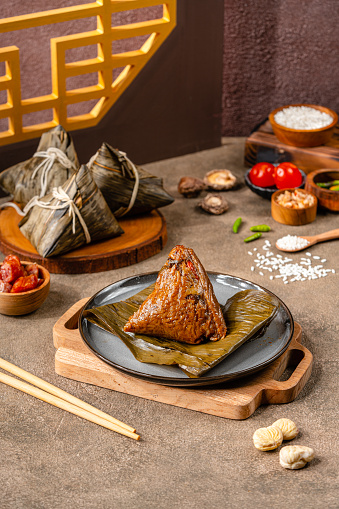 Zongzi is a traditional Chinese food made of glutinous rice stuffed with different fillings and wrapped in bamboo reed, or other large flat leaves. They are cooked by steaming or boiling.