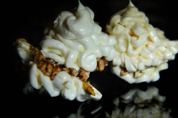 istock Light and airy meringue lies on a glass table reflected in a dark dining room 1477732938