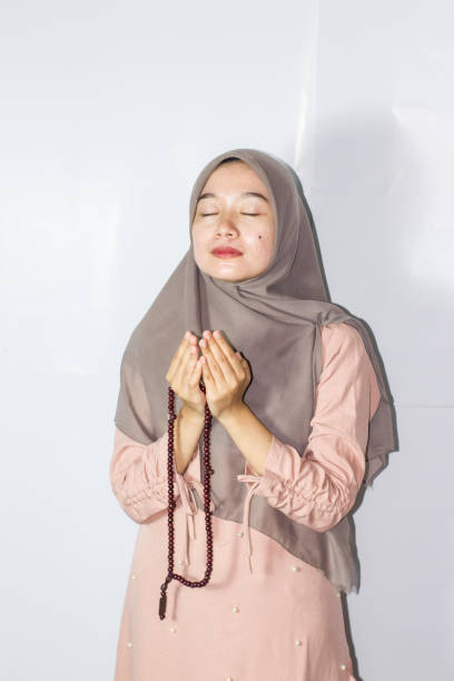 istock young hijab woman praying, Isolated Background 1477732973