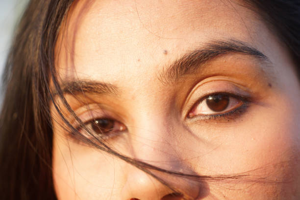 Indian Asian young female macro close up of eyes looking into camera lens stock photo