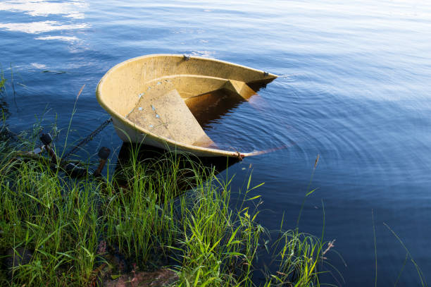 istock Sunken small motor boat on the shore 1477739258