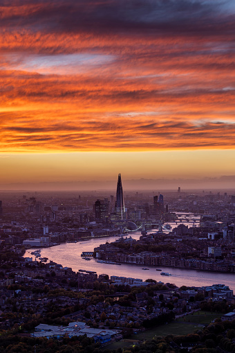 Elevated view of the London skyline with Tower Bridge and River Thames during a colorful sunset, England