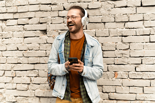 Portrait of a young man enjoying music outdoors