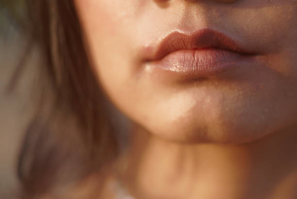Indian Asian young female extreme macro close up of  sharp shaped lips in neutral mood stock photo