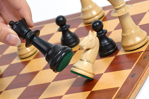 Black chess marker blow over the other