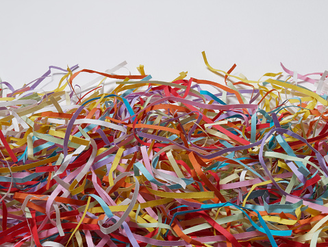 Colored shredded papers on white background. Close-up