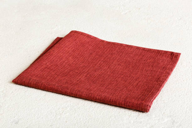 istock top view with red empty kitchen napkin isolated on table background. Folded cloth for mockup with copy space, Flat lay. Minimal style 1477751826