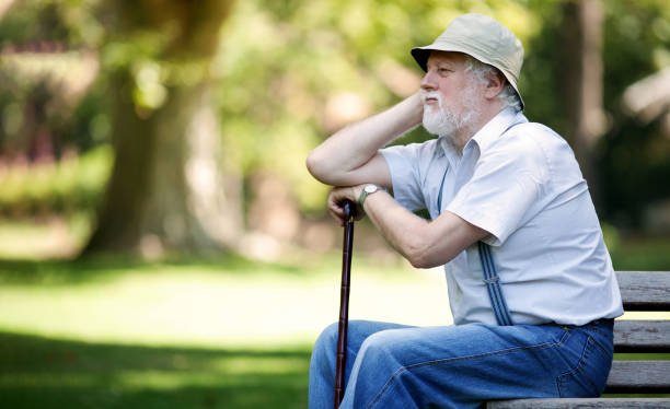 istock Lonely senior sitting in the park 1477754286