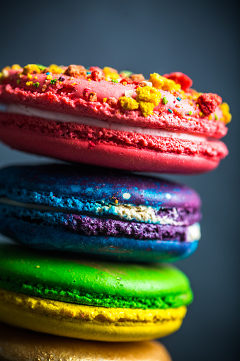 Close up shot of colorful french macaroons  on a black background.