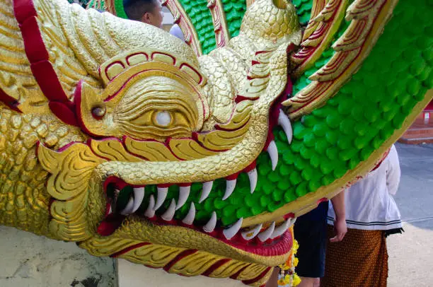 Photo of head of serpent statue in Buddhist temple close-up