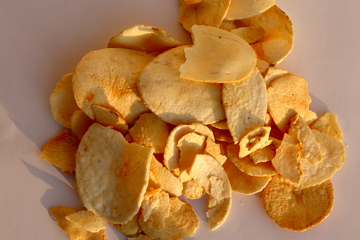 Indian style deep fried chips on white background used as a snack for fasting in Hindu culture