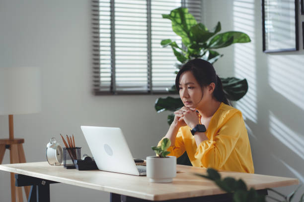 istock Asian woman sitting at home office feel so sad with problem after married. 1477760159