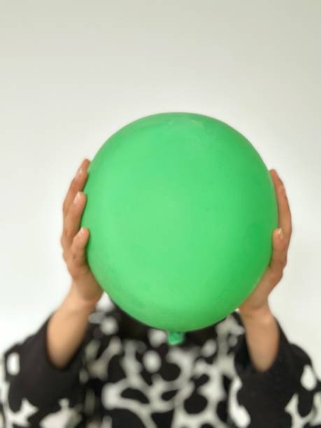 istock An unidentified Woman is holding green balloon 1477760183