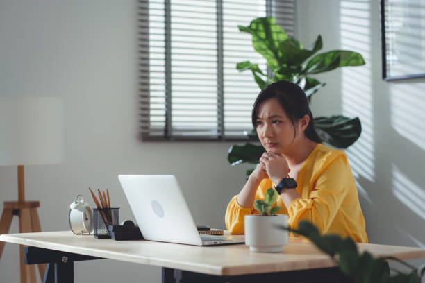 istock Asian woman sitting at home office feel so sad with problem after married. 1477760723