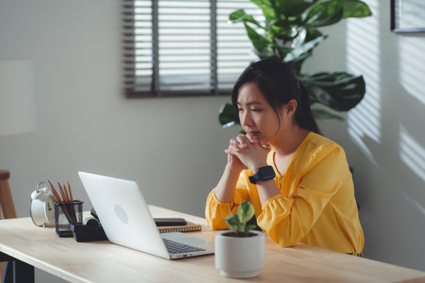 istock Asian woman sitting at home office feel so sad with problem after married. 1477760755