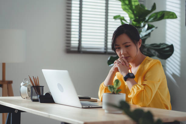 istock Asian woman sitting at home office feel so sad with problem after married. 1477760784