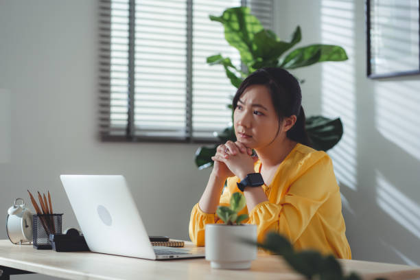 istock Asian woman sitting at home office feel so sad with problem after married. 1477760871
