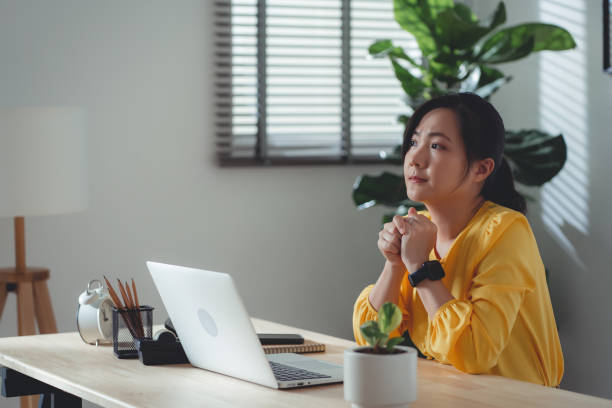 istock Asian woman sitting at home office feel so sad with problem after married. 1477760971