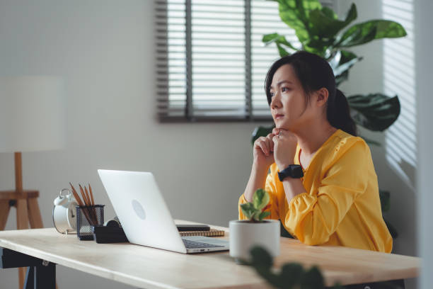 istock Asian woman sitting at home office feel so sad with problem after married. 1477760988