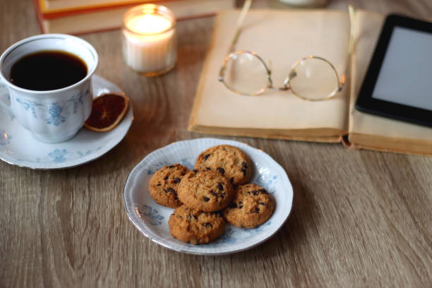 istock Books, Glasses, E-Reader, Pen, Tea, Cookies and Candles 1477765557