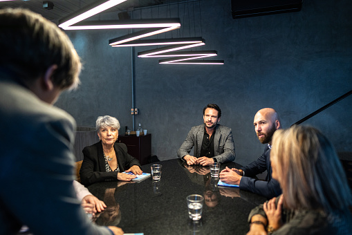 Group of people having a business meeting at the office. Mid adult businessman having a business presentation in the office.