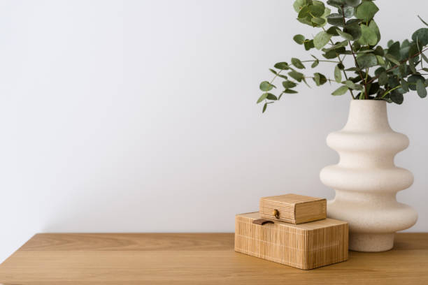 istock decorative storage box and green leaves in ceramic vase on shelf 1477765703