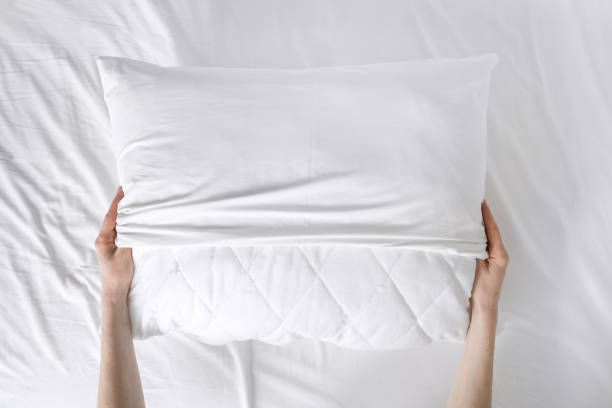 istock woman changing white cotton cover on pillow 1477766527
