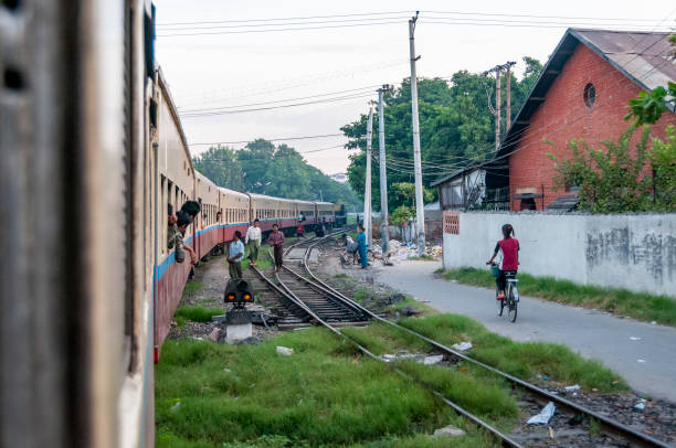 Bago, Myanmar - nov 1,  2012 : the train departing from Bago enters the town of Mandalay, in central Burma