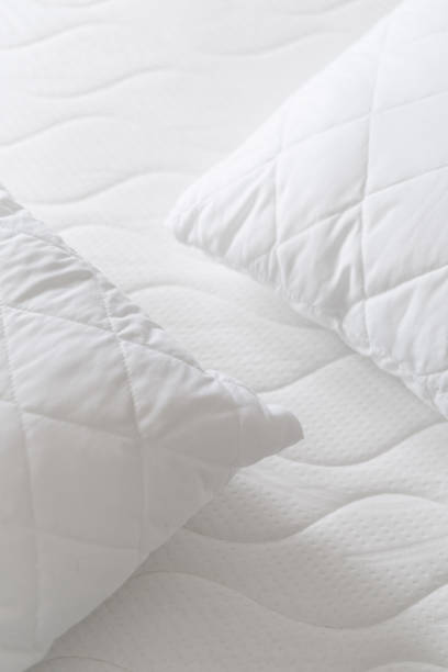 istock background of soft pillows on white quilted mattress 1477767503