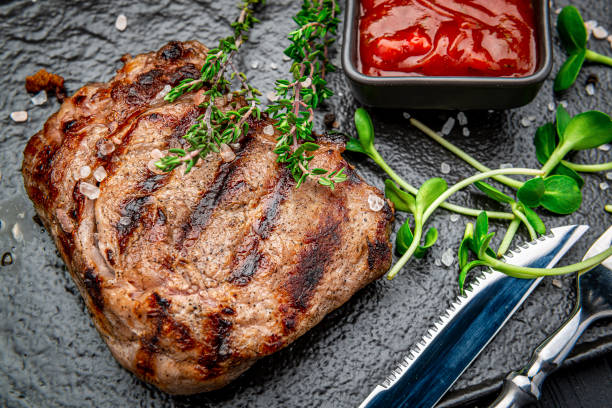 istock Beef rump steak on black stone table. 1477767926