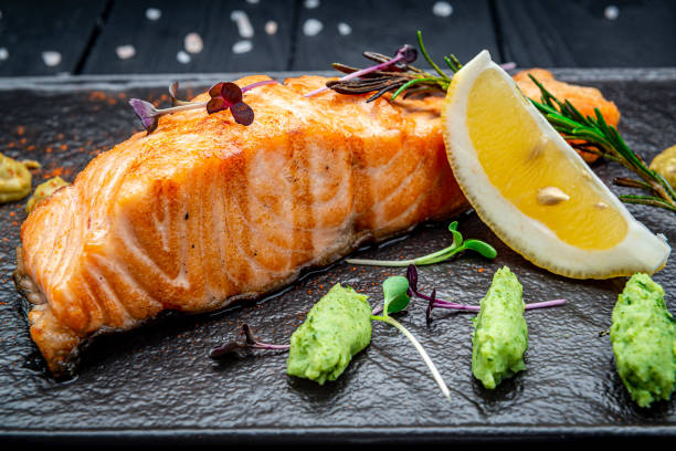istock Grilled salmon and spices on stone plate. Top view 1477767927