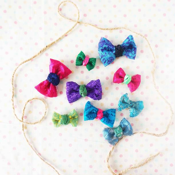 istock Colorful bow tie on white fabric with polka dot background 1477776776