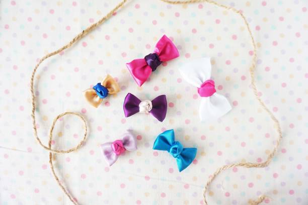 istock Colorful bow tie on white fabric with polka dot background 1477776816