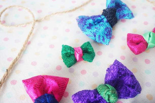 istock Colorful bow tie on white fabric with polka dot background 1477776821