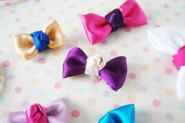 istock Colorful bow tie on white fabric with polka dot background 1477776826
